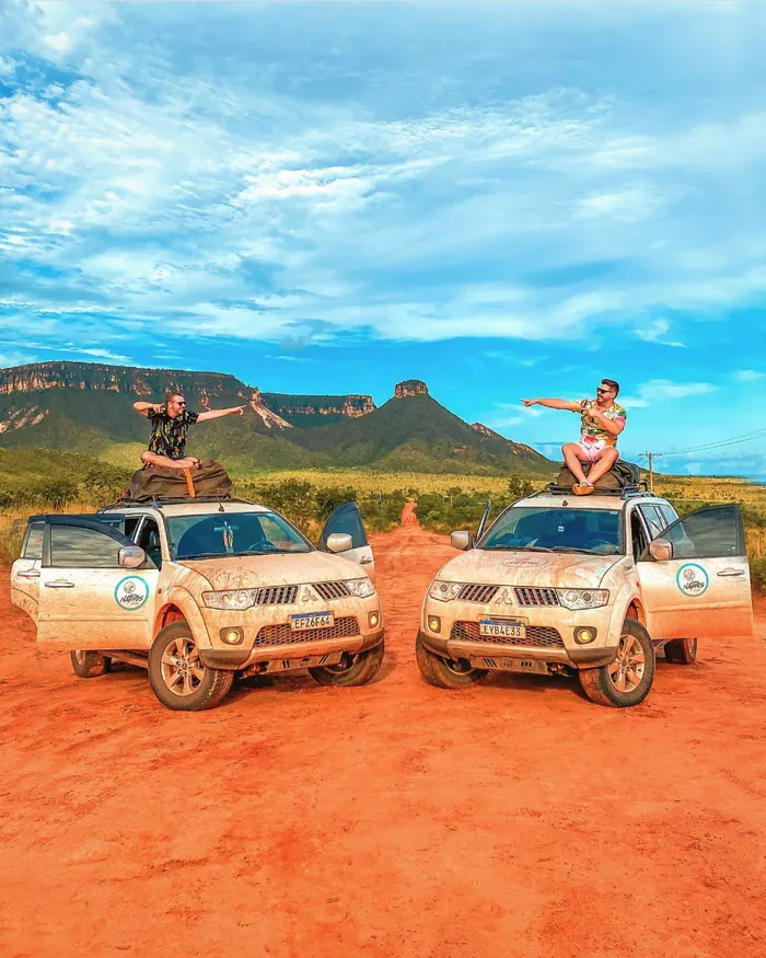 Two travelers on top of the Nativos 4x4s on the road